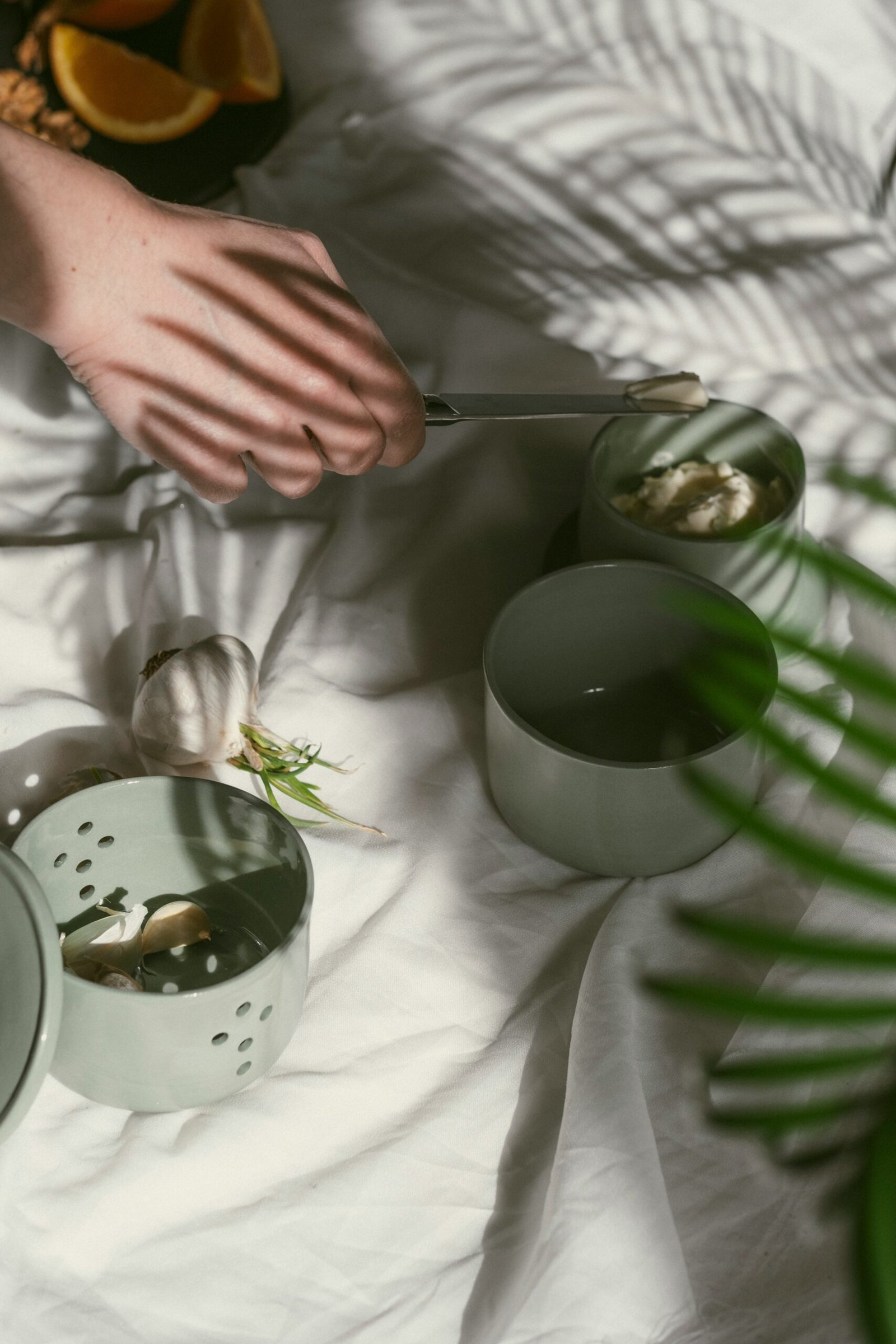 A person cutting a piece of food on a bed