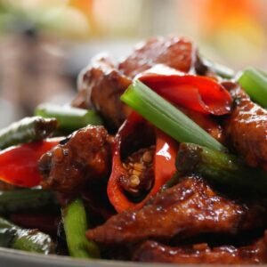 a close up of a plate of food with meat and vegetables