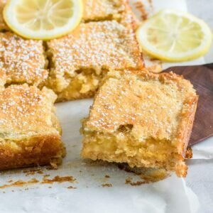 a lemon cake with slices cut out of it