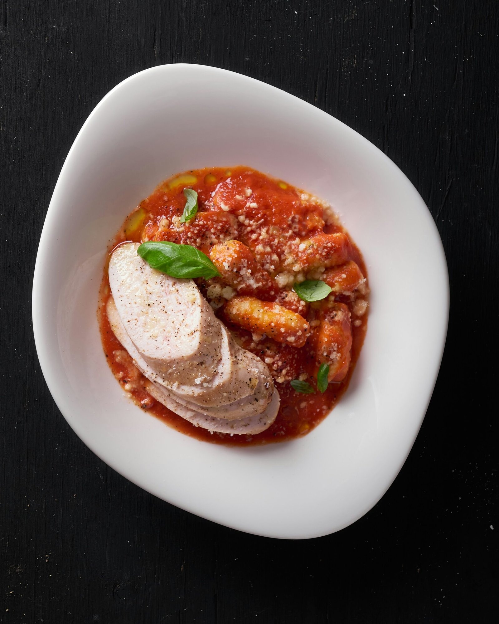 a white plate topped with a meat and vegetable dish