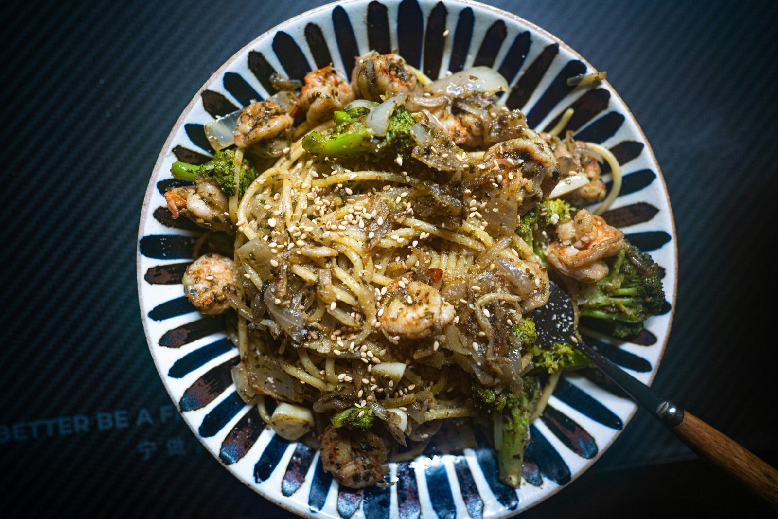 a white plate topped with pasta and broccoli